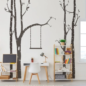 Detail of Nordic wall stickers showing dark grey birch trees with a swing design