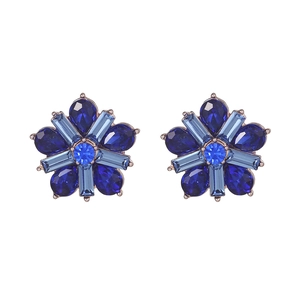 Detailed view of flower-shaped stud earrings with blue gemstones and rose gold finish