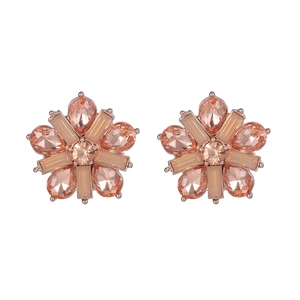 Detailed close-up of champagne pink floral stud earrings with rose gold plating