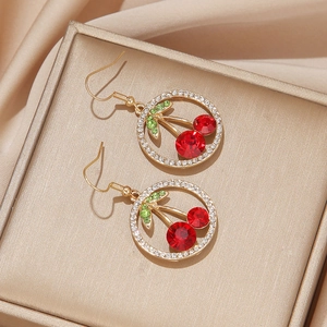 Elegant cherry-shaped drop earrings with red rubies and green crystals on golden base