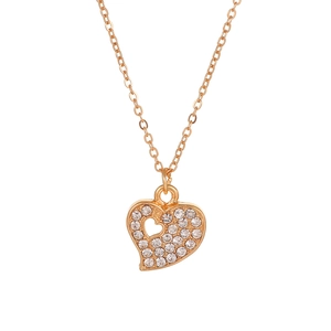Close-up of heart-shaped gold pendant necklace featuring sparkling pavé crystals and cutout