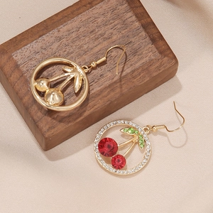 Elegant cherry-shaped alloy drop earrings with sparkling crystals on a silk backdrop