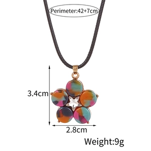 Macro shot of colorful floral pendant with marble resin petals and star crystal center