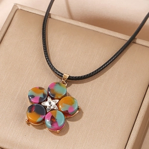 Detailed close-up of a five-petal floral pendant necklace with a center star rhinestone