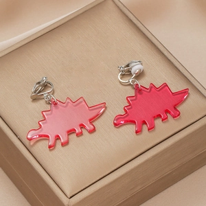 Detail of red acrylic stegosaurus clip-on earrings with silver metal and silicone pads
