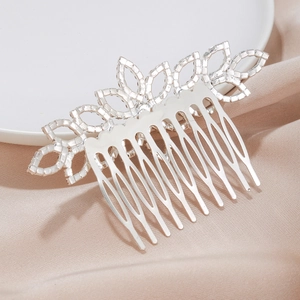 Silver bridal hair comb with floral rhinestone design on elegant silk background