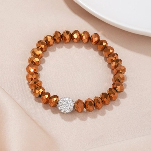Bracelet élastique en perles de bronze facettées avec une boule argentée en strass
