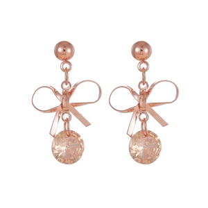 Detail of rose gold bow earrings with dangling champagne crystal and stud design