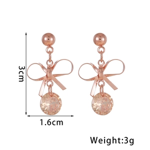 Elegant rose gold copper bow earrings with champagne crystals and tassel pendant