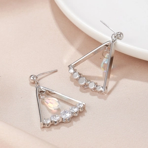 Close-up of triangle tassel earrings with clear zircons and iridescent crystal droplets
