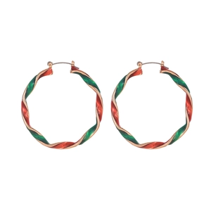 Close-up of twisted hoop earrings with red and green enamel festive color pattern