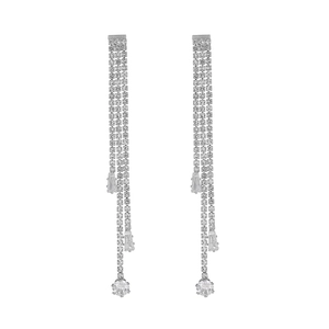 Detail of silver long tassel earrings with sparkling rhinestones and pear-cut zircon