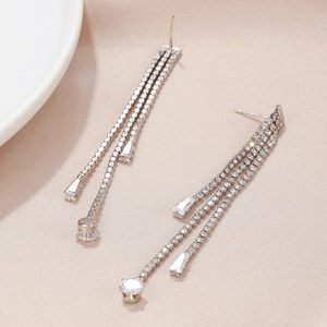 Detailed view of silver tassel earrings with zircon water-drop stones and shiny fringes