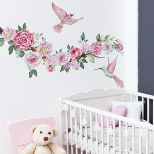 Detail of watercolor pink peonies and hummingbirds wall decals in a cozy nursery room