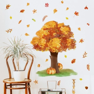 Detailed view of watercolor autumn tree wall decals with pumpkins in a cozy living room