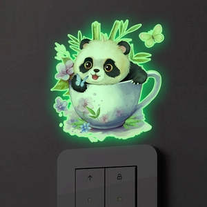 Luminous wall sticker showing a cartoon panda in a teacup glowing green on a dark wall