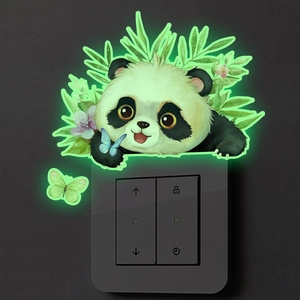 Close-up of glow-in-the-dark panda and butterfly wall stickers on a light switch