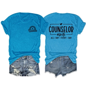 Detail of teal t-shirt with counselor mode print and ripped blue denim shorts