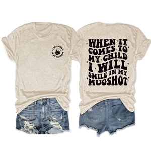 Detail showing vintage slogan print on oatmeal cotton T-shirt and distressed denim shorts