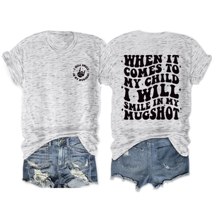Flat lay of gray graphic t-shirt and ripped denim shorts showing front and back designs