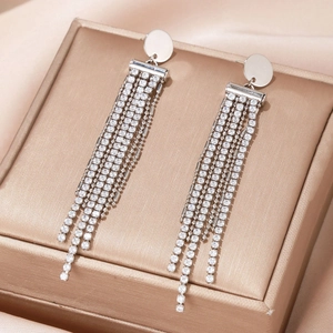 Silver flower tassel earrings with white zircon on a champagne luxury jewelry box