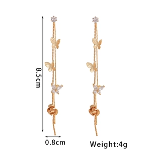 Long gold tassel earrings with butterfly and flower patterns inlaid with white zircon