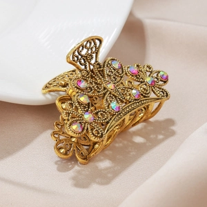 Elegant bronze butterfly hair claw clip with colorful rhinestones on silk fabric