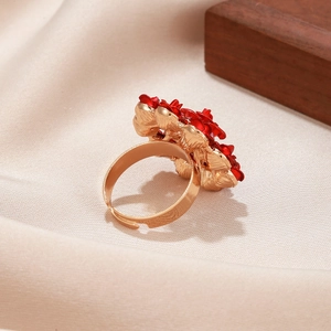 Elegant red rose floral adjustable gold-plated ring on soft beige silk background