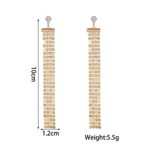Detail showing 10cm long gold tassel earrings with rhinestone flower and product weight