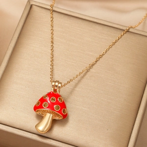 Detailed close-up of red enamel mushroom pendant necklace with golden zircon details
