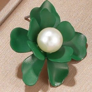 Macro shot of the green matte flower earring featuring a large central white pearl detail