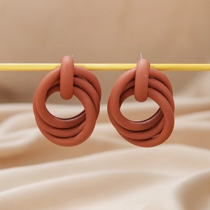 Terracotta matte intertwined triple hoop earrings with a minimalist geometric design