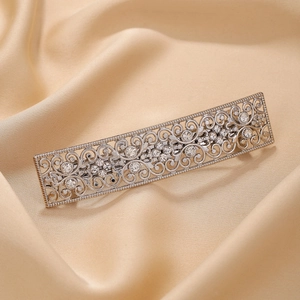 Vintage silver hollow-out hair clip with sparkling crystals on champagne silk