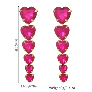 Elegant gold drop earrings featuring vertically aligned rose red heart crystals