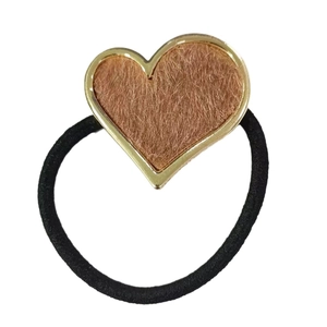 Minimalist heart-shaped hair tie with golden metal frame and brown faux fur inlay