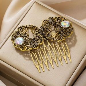 Retro gold alloy hair combs with hollow patterns and iridescent rhinestones in a pair