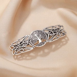 Vintage silver hollow tree hair clip with Celtic knot patterns on champagne silk