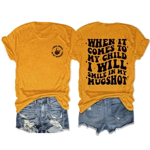 Flat lay of ginger cotton T-shirt with back print and vintage distressed denim shorts