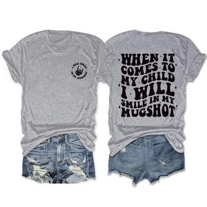 Flat lay of casual grey t-shirt with back print and distressed denim shorts set