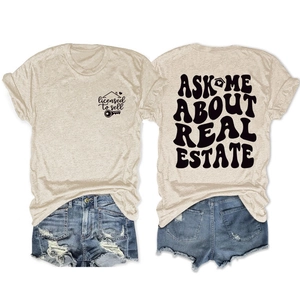 Flat lay of double-sided real estate theme T-shirt and vintage washed denim shorts set