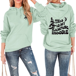Detailed back view of mint green hoodie with pine tree and camping text graphics