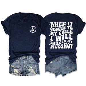 Front and back view of navy blue T-shirt with 'I WILL SMILE IN MY MUGSHOT' white graphics
