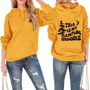 Front and back view of ginger yellow camping hoodie with forest graphics and pocket