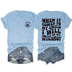 Detail of light blue cotton T-shirt with circular emblem and back typography print