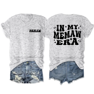 Front and back view of grey Memaw Era T-shirt with vintage print and denim shorts