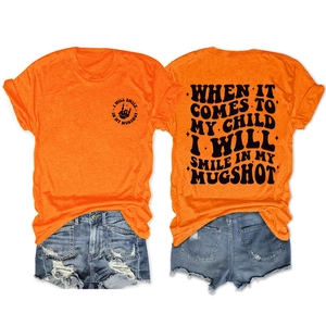 Detail of orange cotton T-shirt featuring black lettering print on front and back view