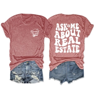 Flat lay of gray real estate t-shirt with back print and distressed denim shorts