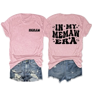 Front and back view of a pink Memaw Era t-shirt paired with distressed denim shorts