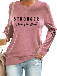 Detail of Stronger Than The Storm text on mauve long-sleeve sweatshirt with heart sleeve print