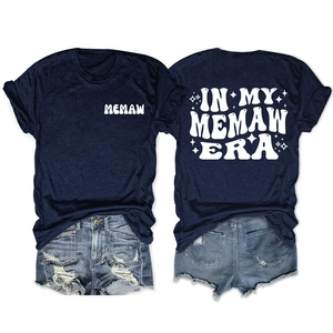 Detail view of double-sided 'In My Memaw Era' print on navy t-shirt with denim shorts